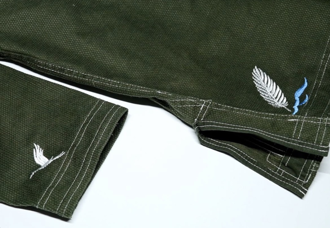 Close view of the Crane Gi trousers showing white contrast stitching and crane marks